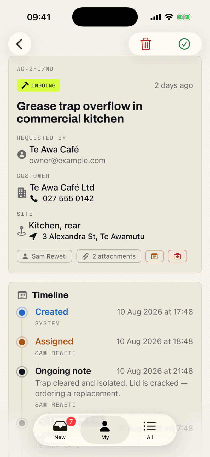 A work order in the app: reference WO-2FJ7ND, an ongoing badge, who requested it, the customer with a tappable phone number, the site and its address, and two attachments.